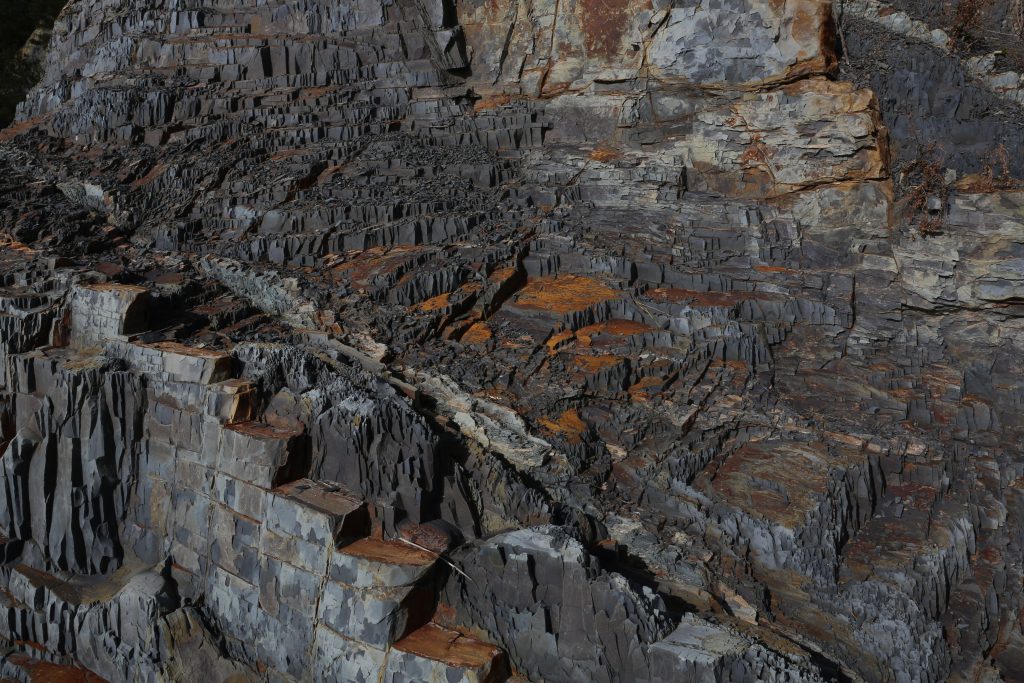 Dramatic terraced rock formation displaying stunning geological features captured from a high angle.