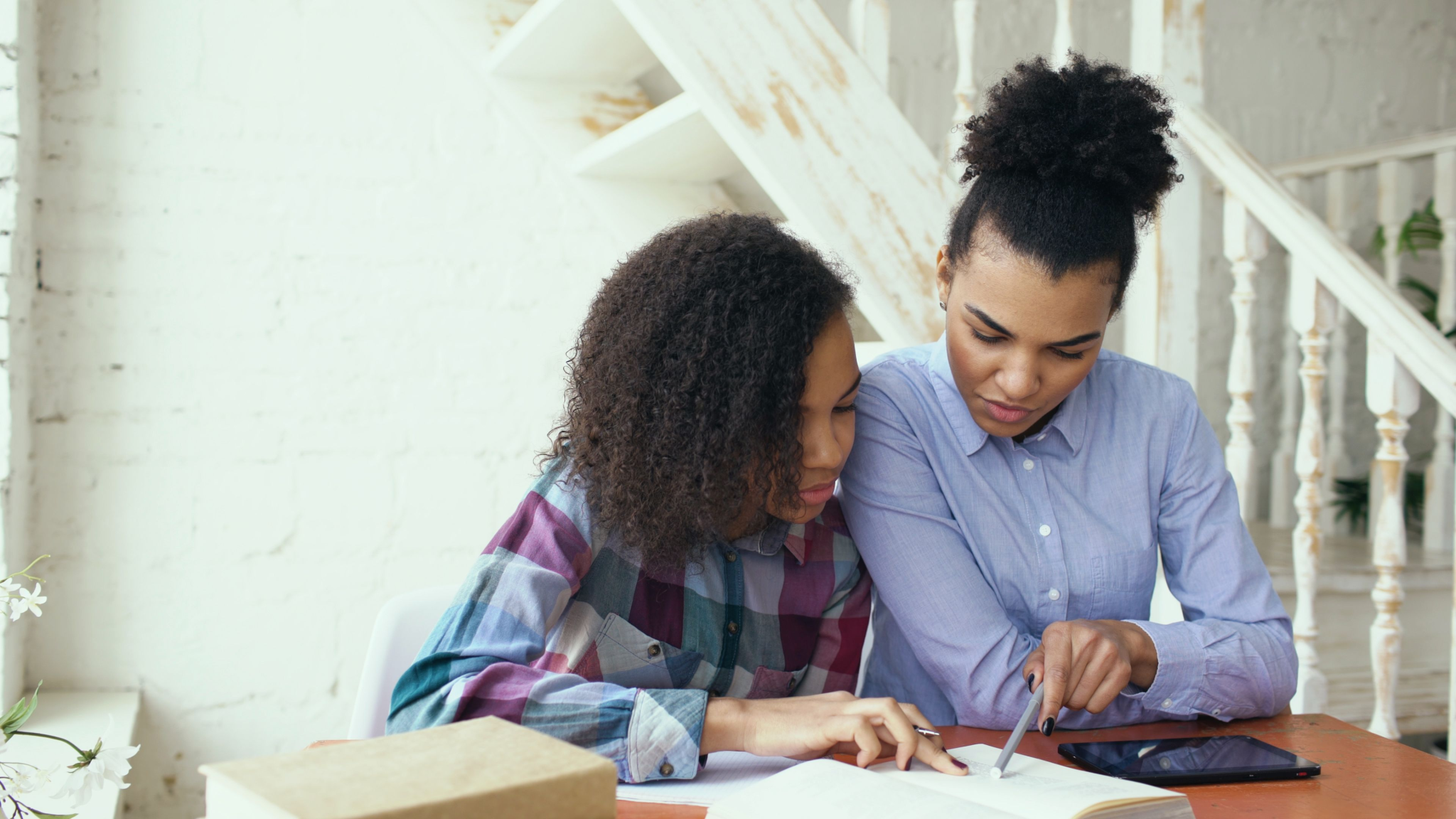 Mother and daughter studying together at home, fostering education and bonding.