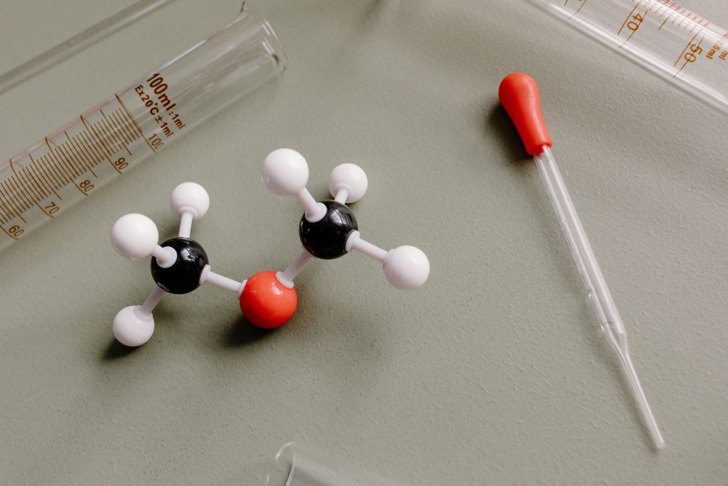 Close-up of laboratory equipment and molecular model on a flat surface.