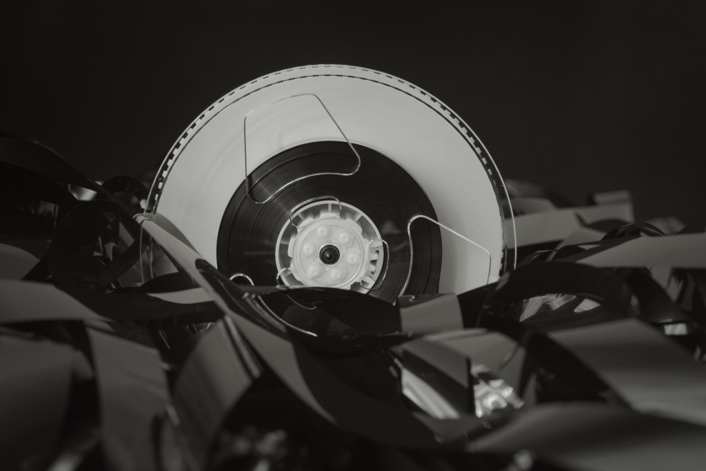 Close-up of a vintage cassette tape against a black background, showcasing retro technology.